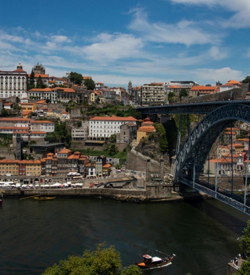 Scenic view of Porto, Portugal featuring the iconic Dom Luís I Bridge over the Douro River.