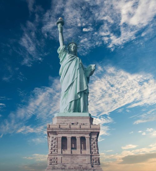 Iconic Statue of Liberty with a backdrop of a vibrant blue sky, symbolizing freedom and America.